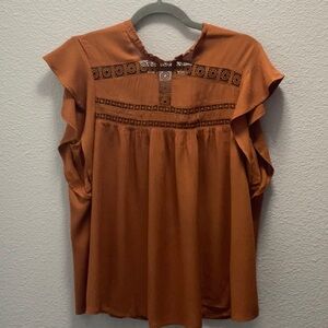 This self esteem size large top is rust in color with lace design in its bodice.
